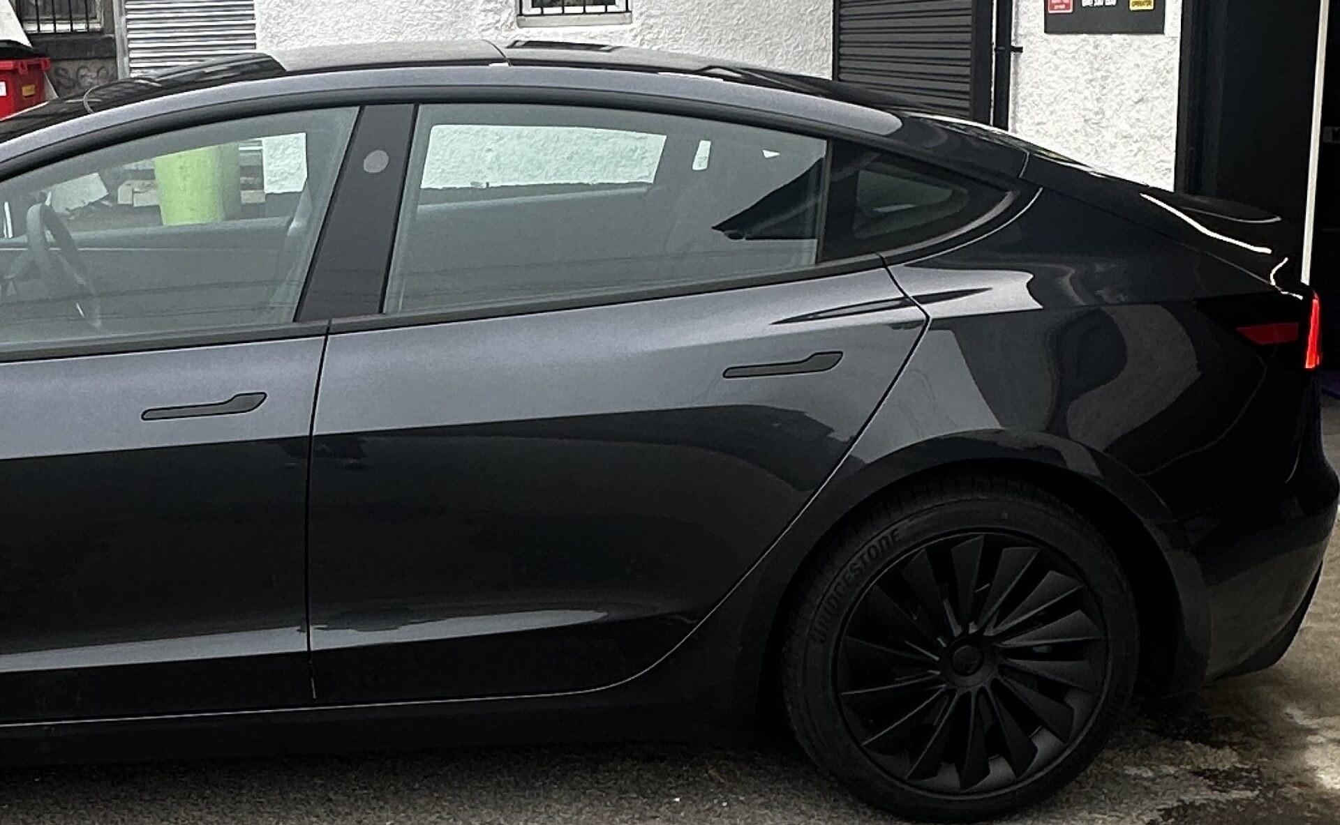 Tesla rear window before professional tinting